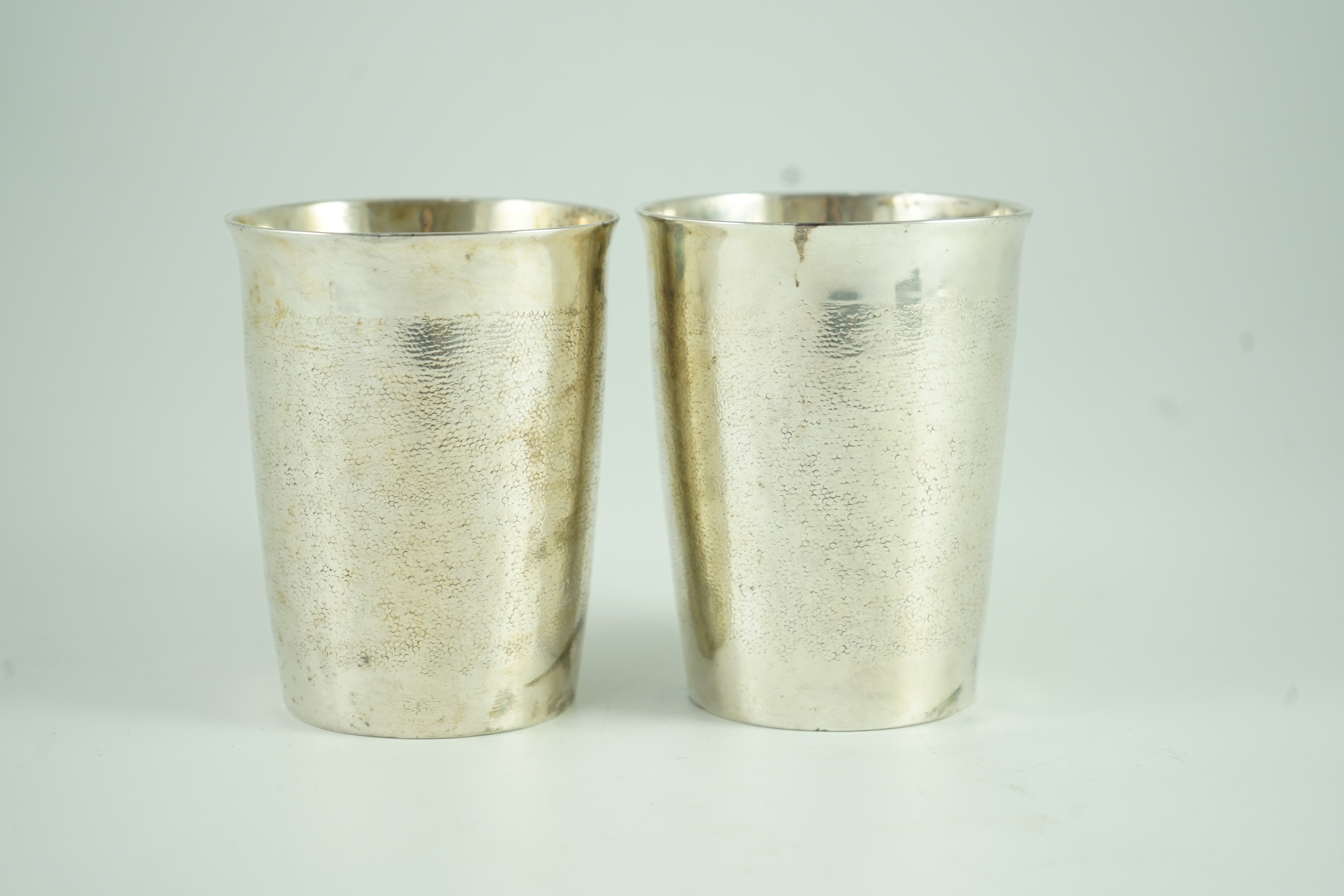 A pair of George III part textured silver beakers, by Henry Chawner
